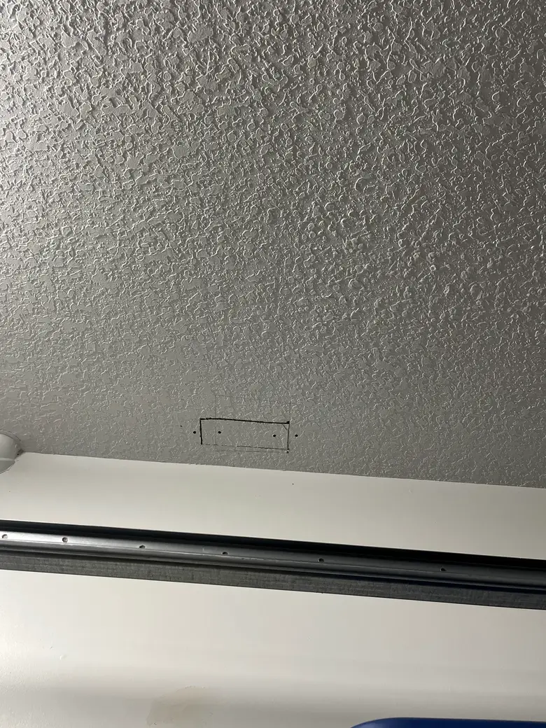 Before: a drywall patch marked out on the ceiling