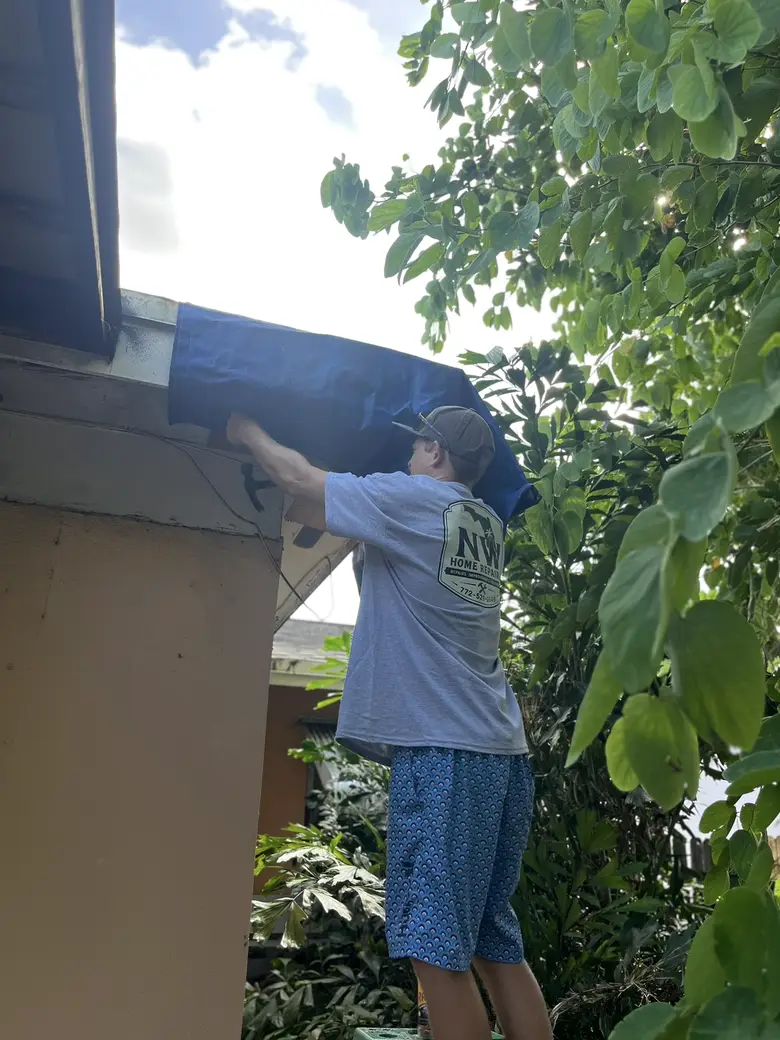 Nick at work under an eave in his NW Home Repairs shirt