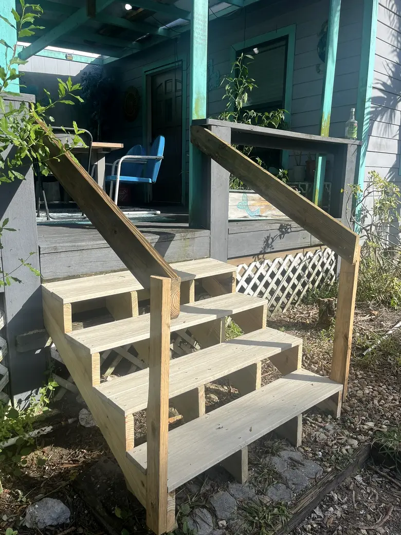 Brand new porch steps in fresh lumber, built, railed and ready